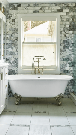 Image may contain Bathing Bathtub Person Tub Indoors Interior Design Sink and Sink Faucet